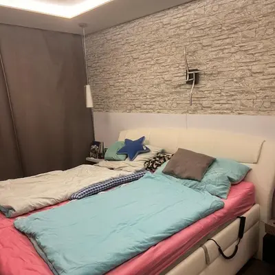 a bed with two pillows on it in a room at Big apartment in quiet location close to the center -ideal for families with kids in Prague
