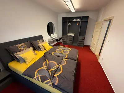 a bedroom with a large bed with yellow sheets at Romantic Apartment in historical house from 1398 in Prague city centre in Prague