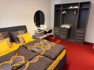 a bedroom with a large bed and a mirror at Romantic Apartment in historical house from 1398 in Prague city centre in Prague