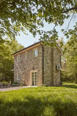 a brick house in the middle of a grass field at Nad svatým Kiliánem