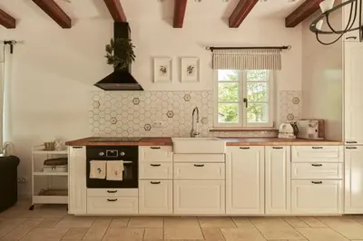 a kitchen with white cabinets and a stove at Nad svatým Kiliánem