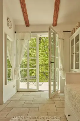 a bedroom with a bed and a large sliding glass door at Nad svatým Kiliánem