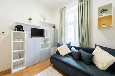 a living room with a couch and a tv at Bella Vita in Prague