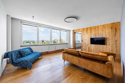 a living room with a couch and a tv at Urban Oasis Stodůlky in Prague