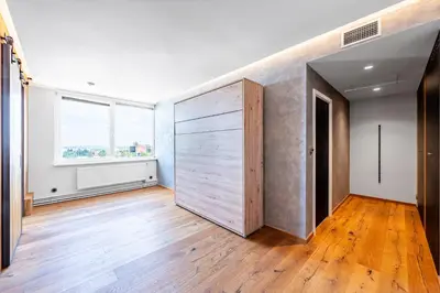 a room with a wooden door in a room with a window at Urban Oasis Stodůlky in Prague