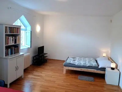 a bedroom with a bed and a book shelf at Ubytování nad kostelem in Prague