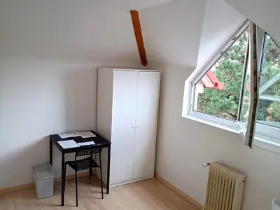 a small room with a desk and a window at Ubytování nad kostelem in Prague