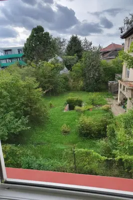 a view of a garden from a window at Ubytování nad kostelem in Prague