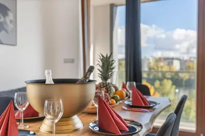 a wooden table with a bowl of fruit on it at Terrace Royale in Prague