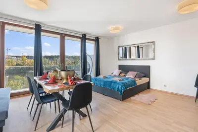 a bedroom with a bed and a tv on the wall at Terrace Royale in Prague