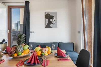 a kitchen and a living room with a table and chairs at Terrace Royale in Prague