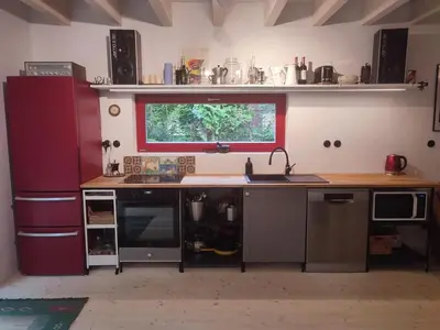 a kitchen with a counter with a sink and a window at Romantický domek Slapy