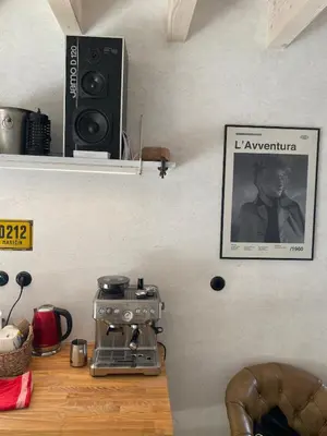 a kitchen counter with a coffee machine and a speaker at Romantický domek Slapy