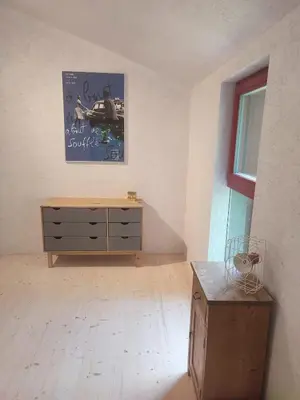 a room with a dresser and a picture on the wall at Romantický domek Slapy