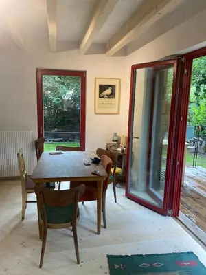 a dining room with a wooden table and chairs at Romantický domek Slapy