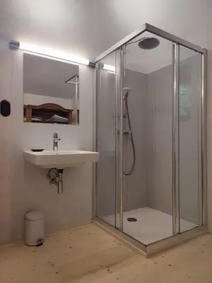 a bathroom with a shower and a sink at Romantický domek Slapy