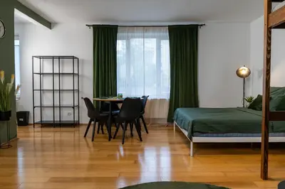 a bedroom with a bed and a table and chairs at The Green Loft Studio - 10 min to City Center in Prague