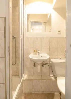 a bathroom with a sink and a toilet at Muze Suites in Prague