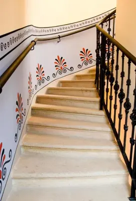 a staircase with a mural of flowers on the wall at Prague Mystique Apartment in Prague