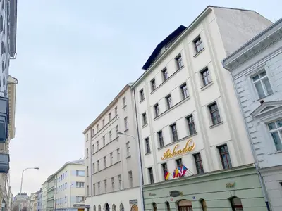 a white building with a sign on the side of it at Prague Mystique Apartment in Prague