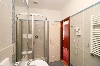 a bathroom with a shower and a toilet and a sink at Prague Mystique Apartment in Prague