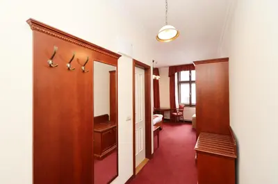 a corridor of a room with a door and a bedroom at Prague Mystique Apartment in Prague
