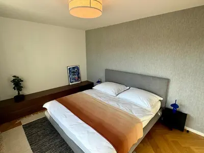 a bedroom with a large bed in a room at Luxury Penthouse - Castle View, Terrace, Center in Prague