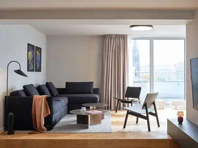 a living room with a couch and a table at Luxury Penthouse - Castle View, Terrace, Center in Prague