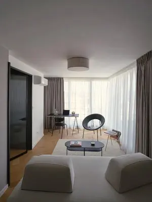 a living room with a couch and a table at Luxury Penthouse - Castle View, Terrace, Center in Prague