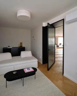 a living room with a white couch and a table at Luxury Penthouse - Castle View, Terrace, Center in Prague