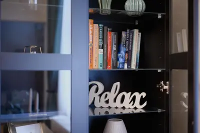 a book shelf with books and a sign on it at Old town apartment Kaprova in Prague