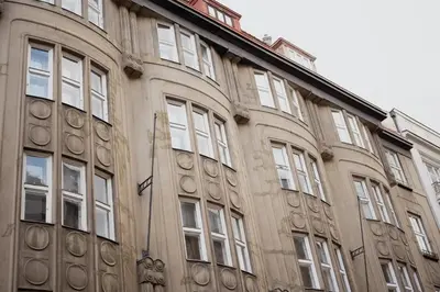 a building with a flag on the side of it at Old town apartment Kaprova in Prague