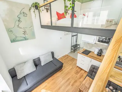 a living room with a couch and a bed at Apartment Čelakovsky-3 by Interhome in Prague