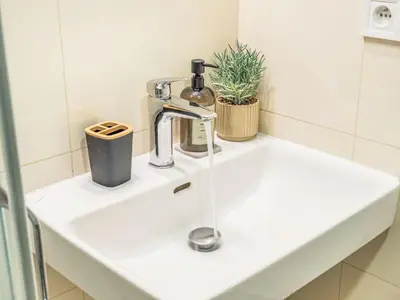 a white sink in a bathroom with a faucet at Apartment Čelakovsky-3 by Interhome in Prague