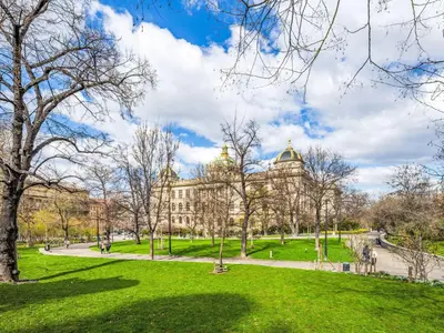a building in a park with green grass and trees at Apartment Čelakovsky-3 by Interhome in Prague