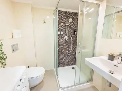 a bathroom with a shower and a toilet and a sink at Apartment Čelakovsky-3 by Interhome in Prague