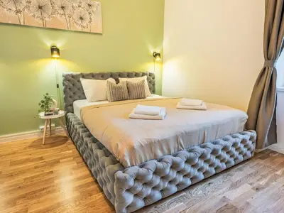 a bed with two towels on it in a bedroom at Apartment Washington-5 by Interhome in Prague