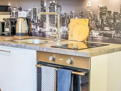 a kitchen with a sink and a city mural on the wall at Apartment Washington-5 by Interhome in Prague