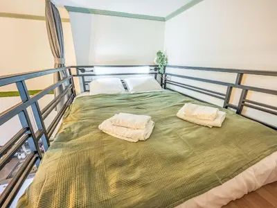 a bed in a room with two towels on it at Apartment Washington-5 by Interhome in Prague