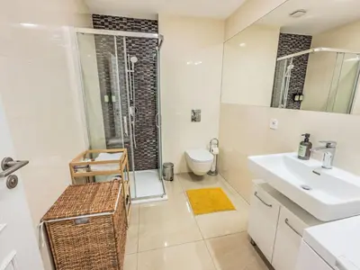 a bathroom with a sink and a shower and a toilet at Apartment Washington-5 by Interhome in Prague