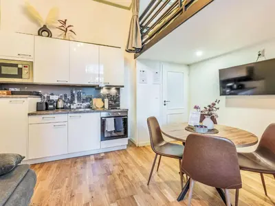 a kitchen and dining room with a table and chairs at Apartment Washington-5 by Interhome in Prague