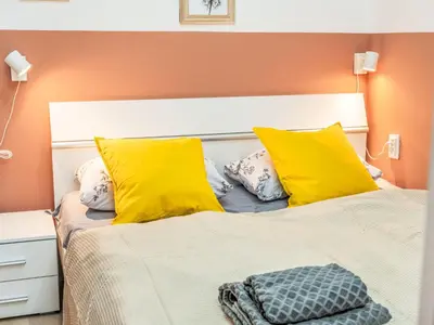 a bedroom with a bed with yellow pillows at Apartment Washington-4 by Interhome in Prague