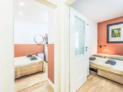 a room with two beds and a door at Apartment Washington-4 by Interhome in Prague