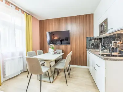 a dining room with a white table and chairs at Apartment Washington-4 by Interhome in Prague