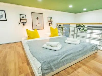 a bedroom with a large bed with yellow pillows at Apartment Čelakovsky-4 by Interhome in Prague