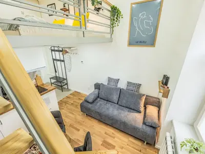 a living room with a couch and a staircase at Apartment Čelakovsky-4 by Interhome in Prague