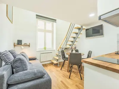 a living room with a couch and a table at Apartment Čelakovsky-4 by Interhome in Prague