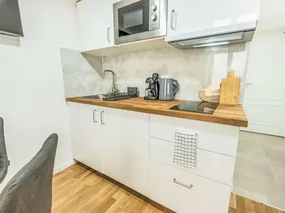 a kitchen with white cabinets and a sink at Apartment Čelakovsky-4 by Interhome in Prague