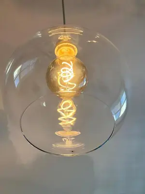 a glass lid with a gold object on a table at Urban Nest On Tyrsova 7 - Near IP Pavlova Metro in Prague