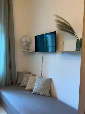 a bedroom with a bed with a tv on the wall at Urban Nest On Tyrsova 7 - Near IP Pavlova Metro in Prague